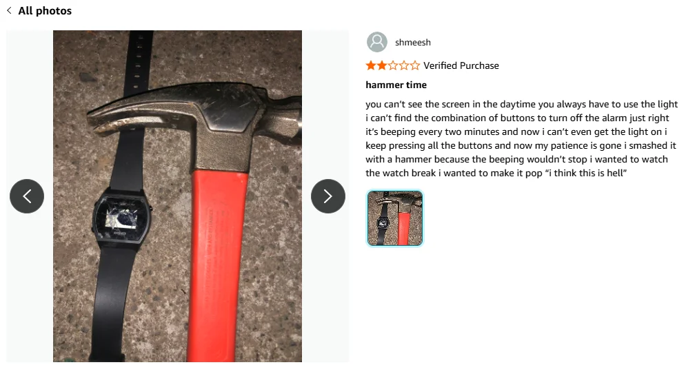 A hammer with a red handle is placed next to a black digital wristwatch on a white surface; the image is part of a humorous product review about smashing the watch.